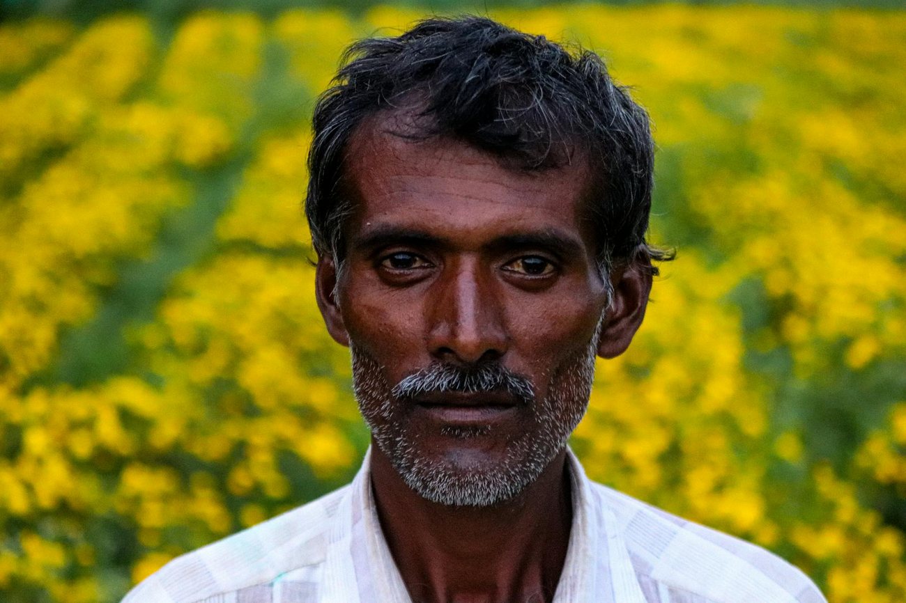 Close-up portrait of a senior Indian man in a vibr