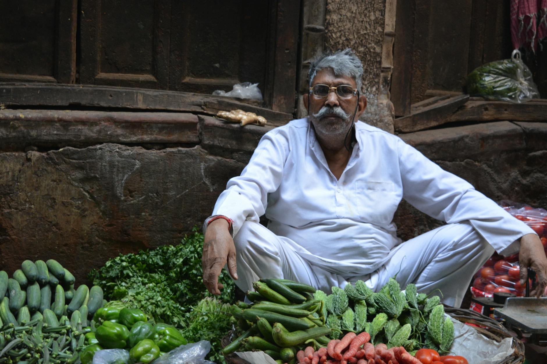 Local vegetable seller amongst fresh produce