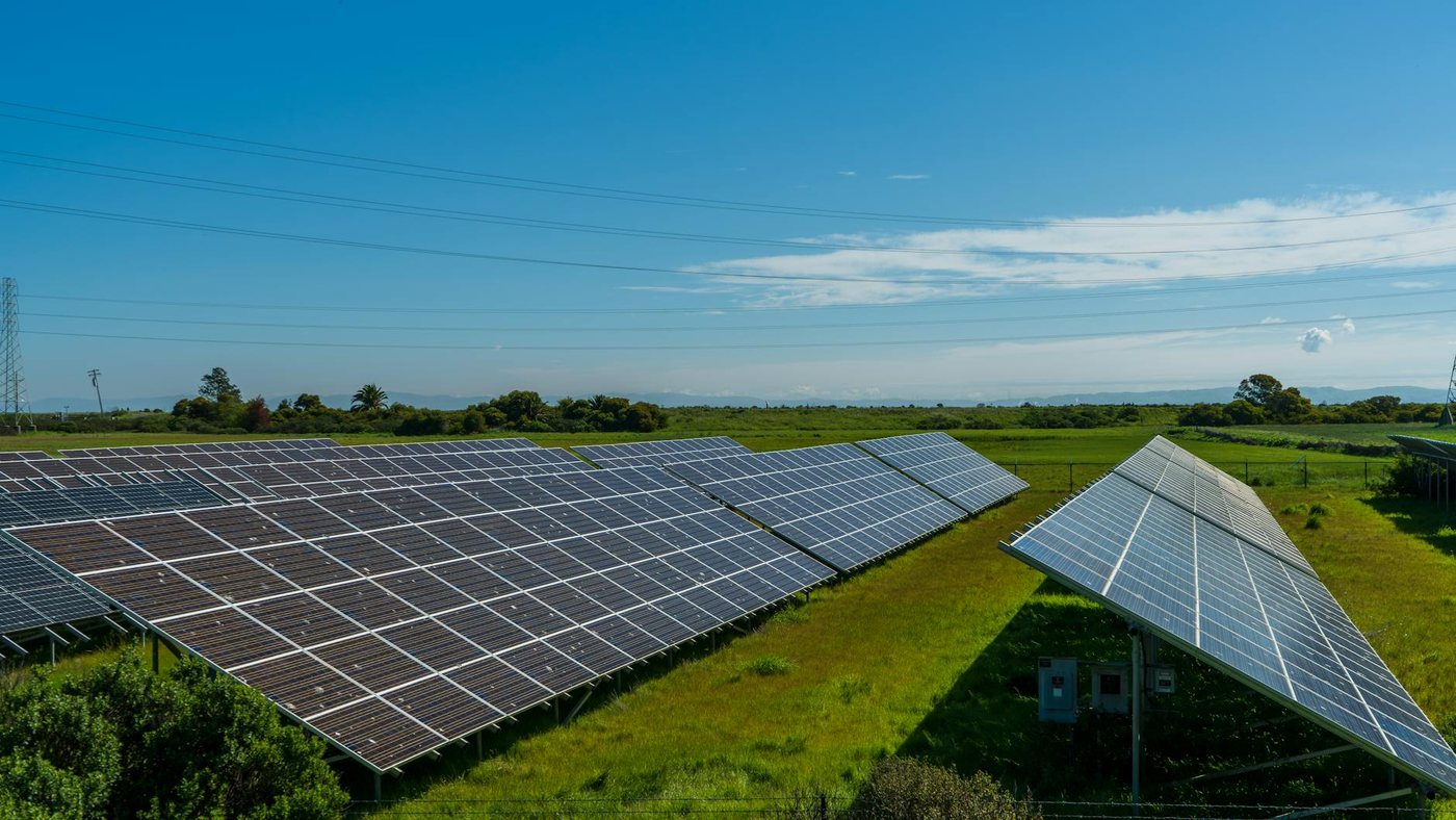 Solar panels in a lush rural field, generating ren