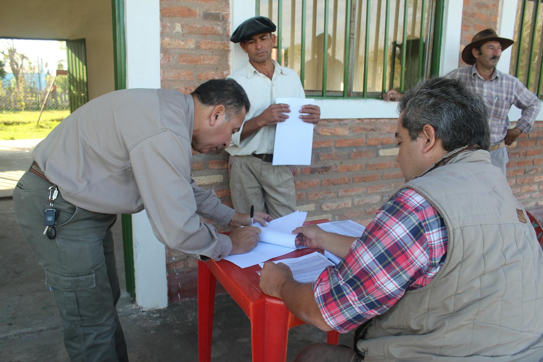 Farmers signing scheme paperwork outdoors
